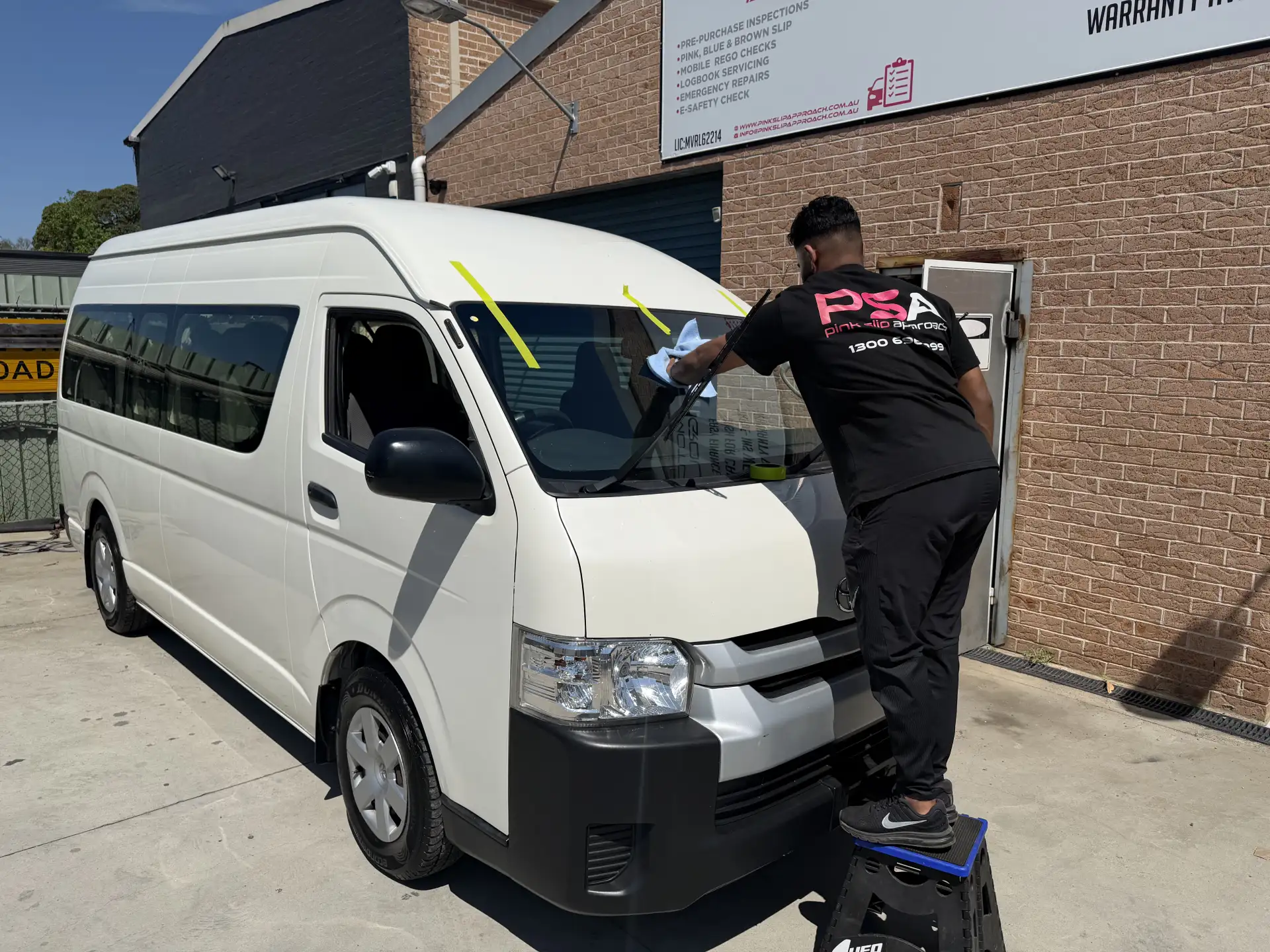 A PSA technician checking a white van